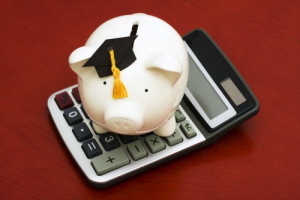 Piggy bank with graduation cap and calculator